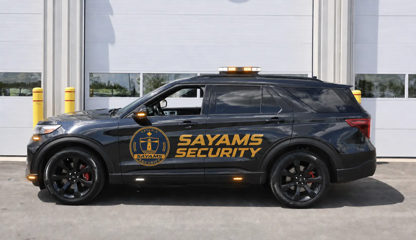Black SAYAMS Security Ford Explorer with the company badge, door branding, and amber and white safety lights
